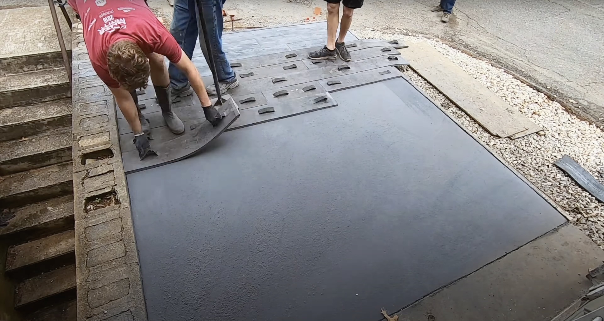 Professional concrete surface finishing and texturing Professional concrete finishing work showing smooth surface creation with specialized tools