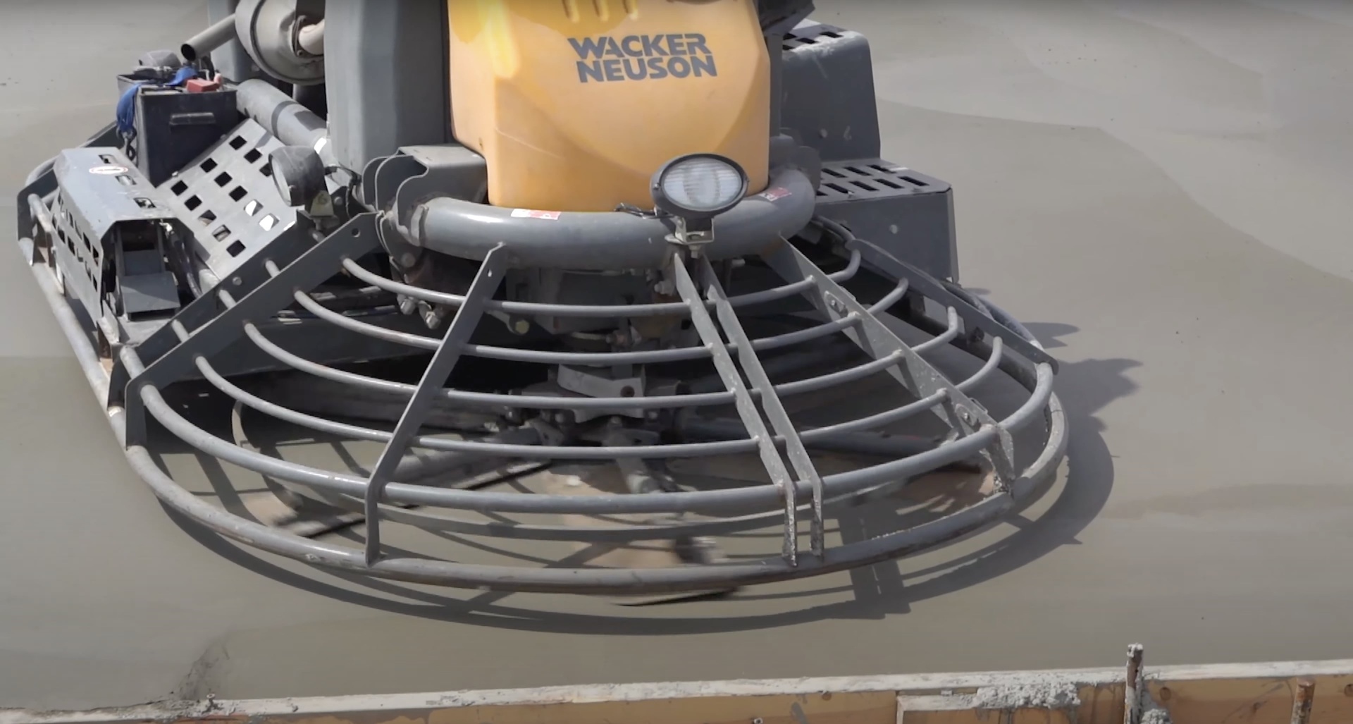 Professional concrete finishing equipment and techniques Professional concrete finishing equipment showing power trowel used for smooth surfaces