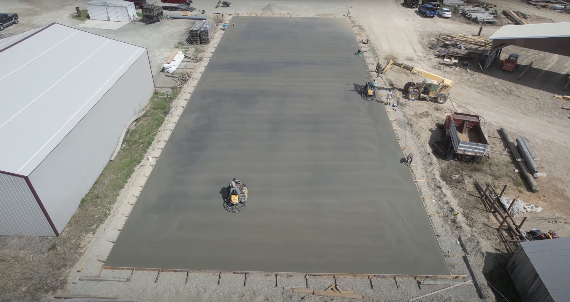 Commercial concrete slab installation - Southfield Concrete Construction Large commercial concrete slab installation with professional finishing equipment