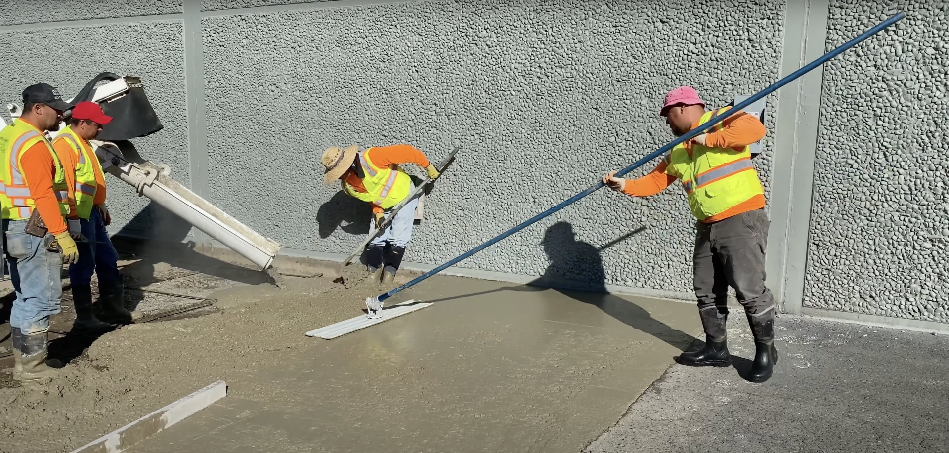 Professional concrete construction team at work Professional concrete construction crew working on commercial project with proper safety equipment